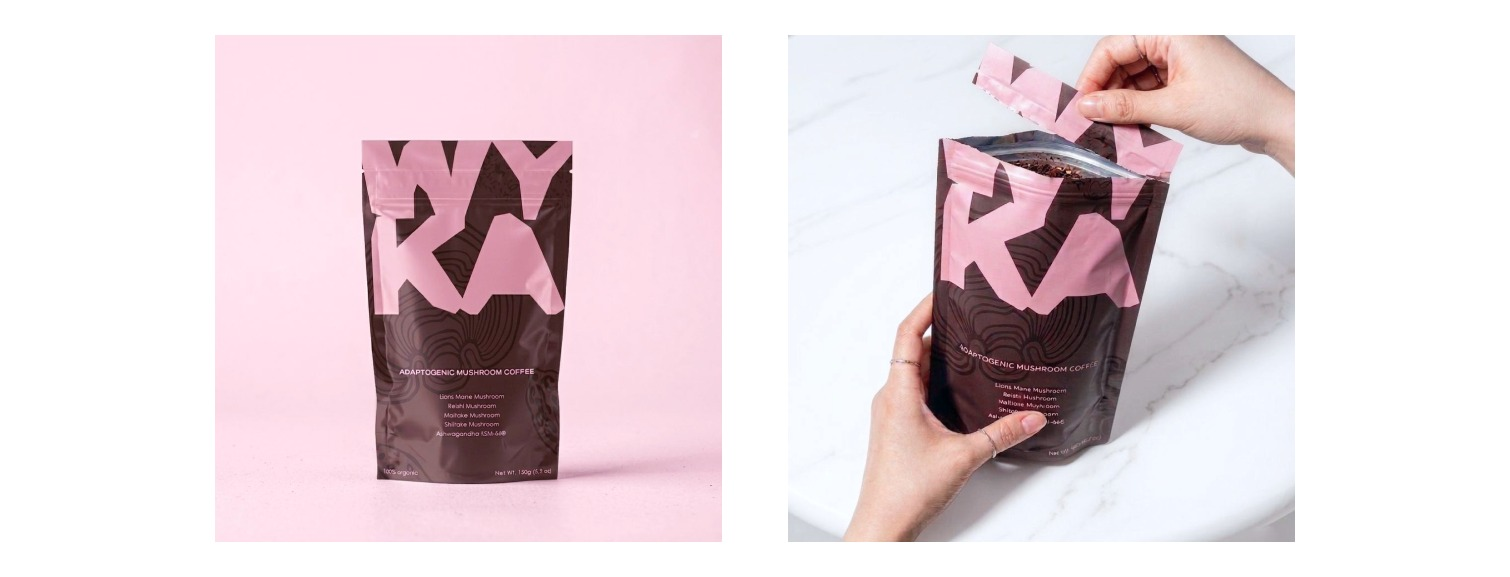 WYKA coffee packaging shown on a pink surface and held while being opened